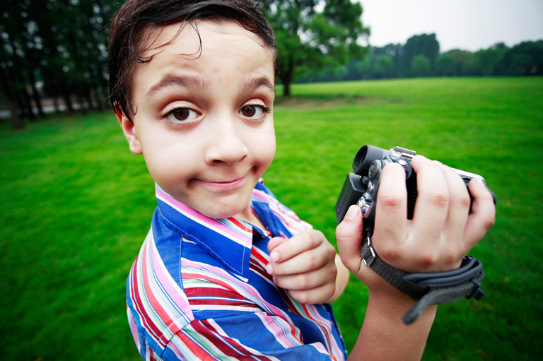 Make money on YouTube - Boy holding camcorder