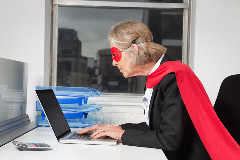 Become a YouTube star — woman wearing superhero costume at computer